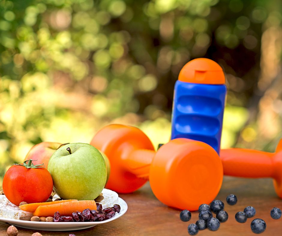 fruits, dumbells and a water bottle on a table